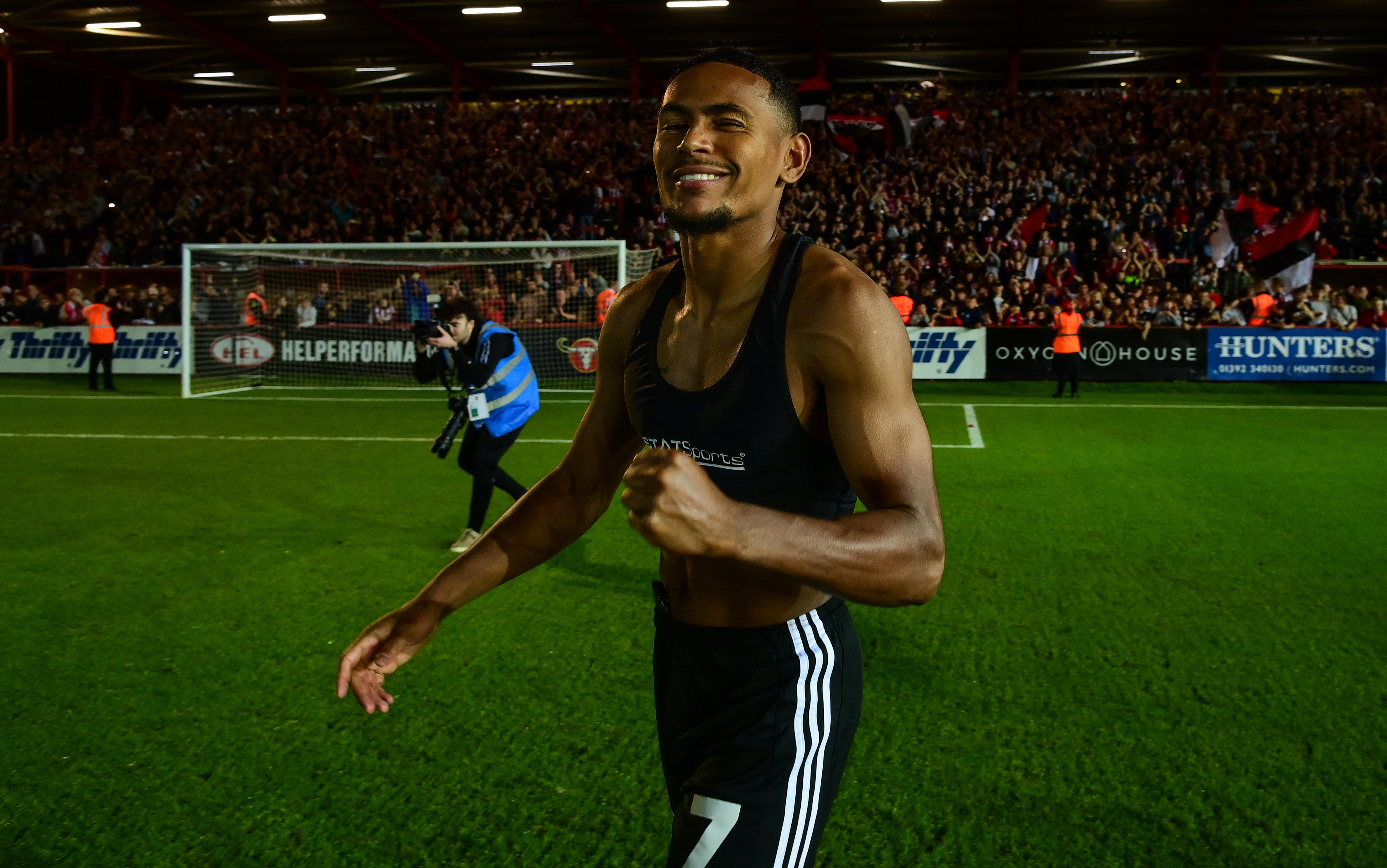 Demetri Mitchell celebrating after Exeter City's win over Luton Town