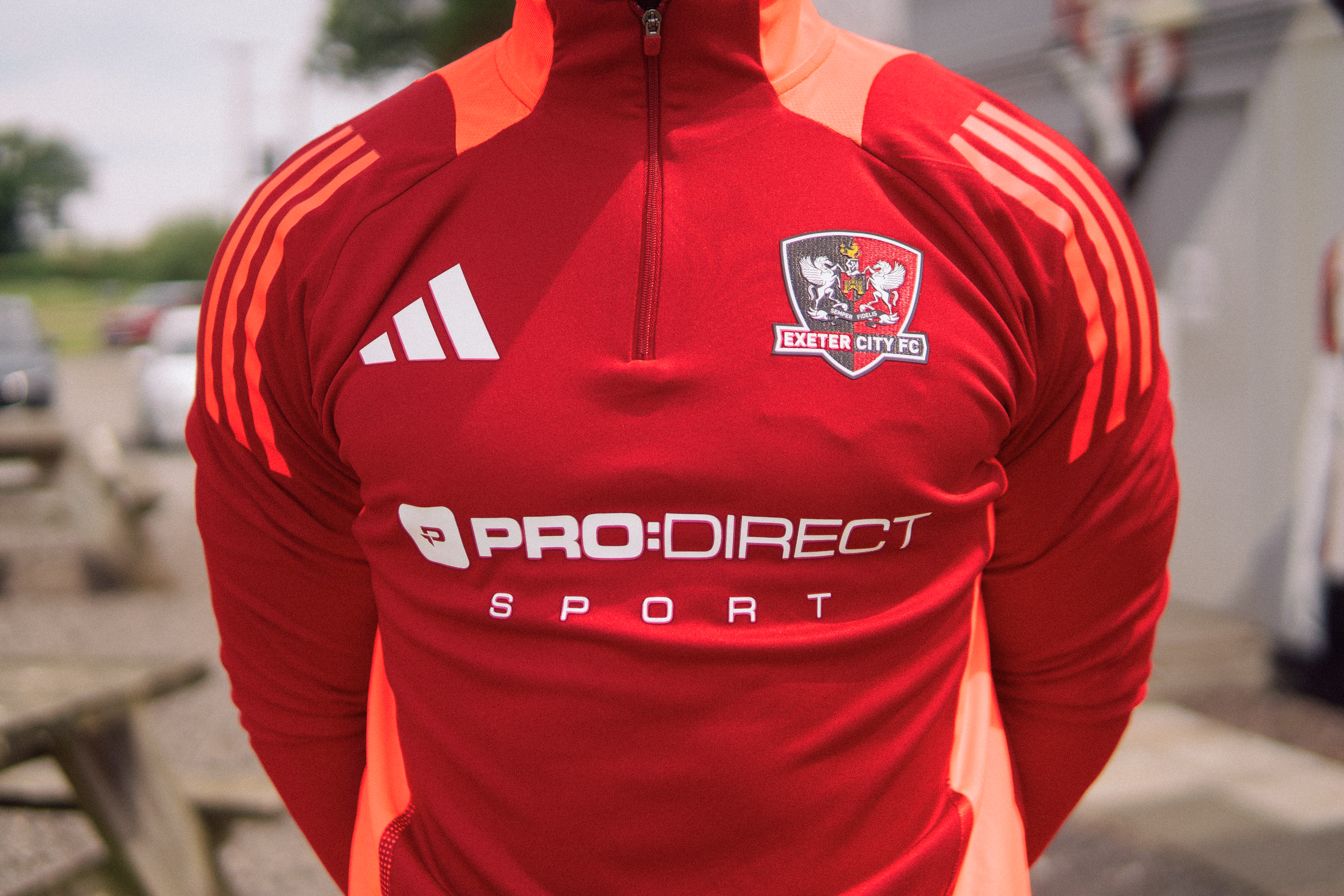 Close up of a red Exeter City training top with the Pro:Direct logo
