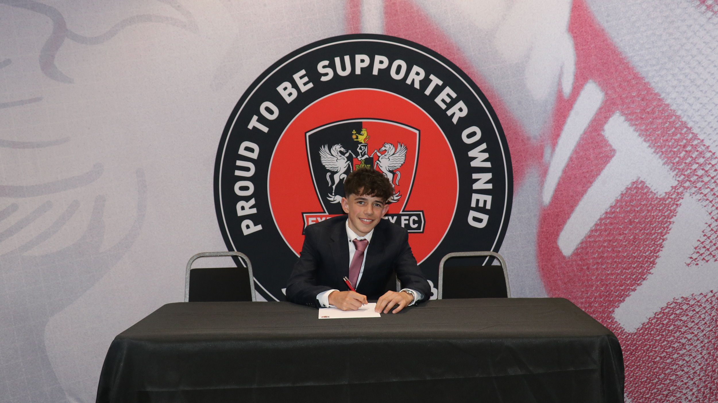 Image of Aidan Bown signing his scholarship