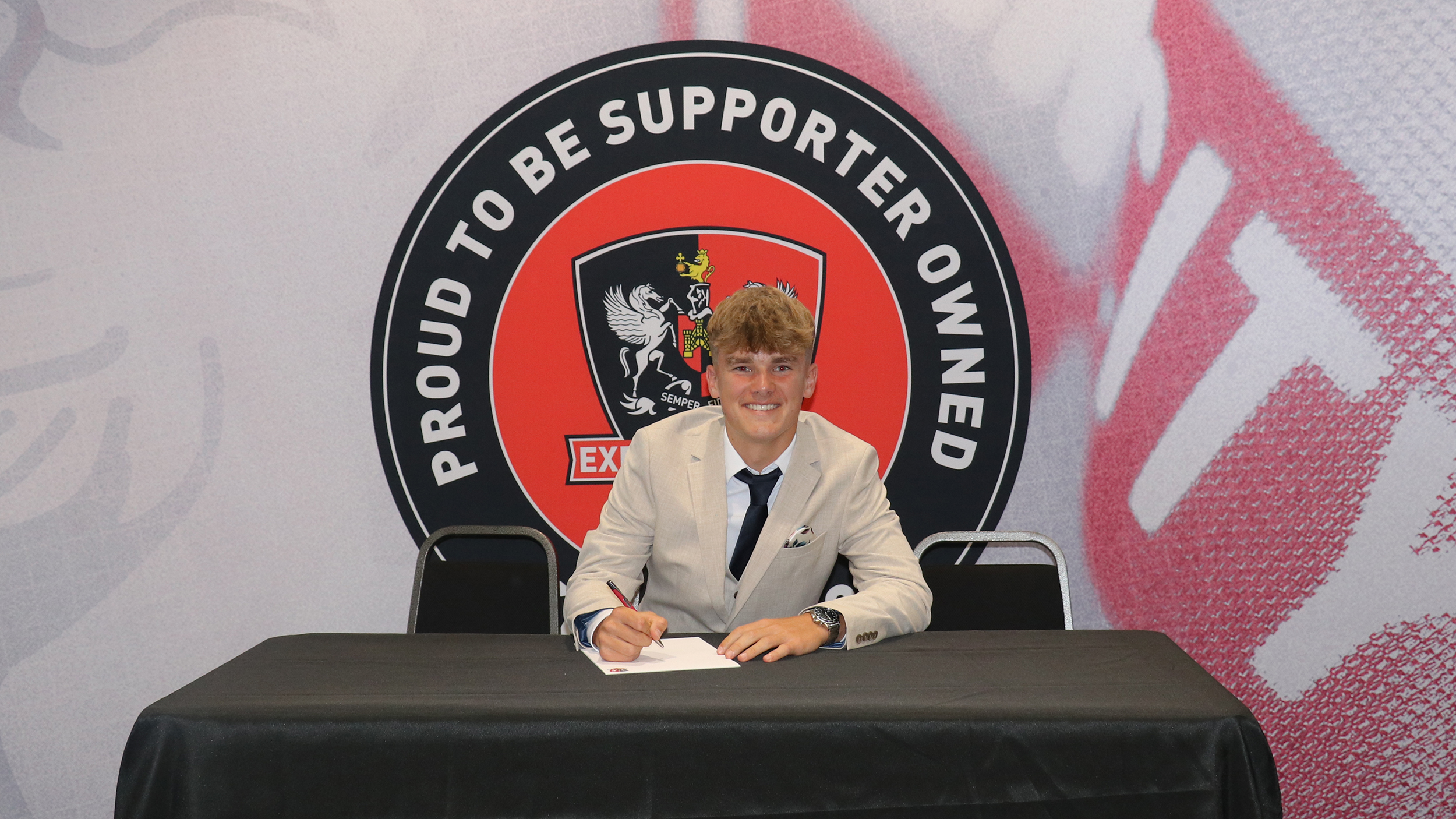 Image of Harry Crees signing his scholarship