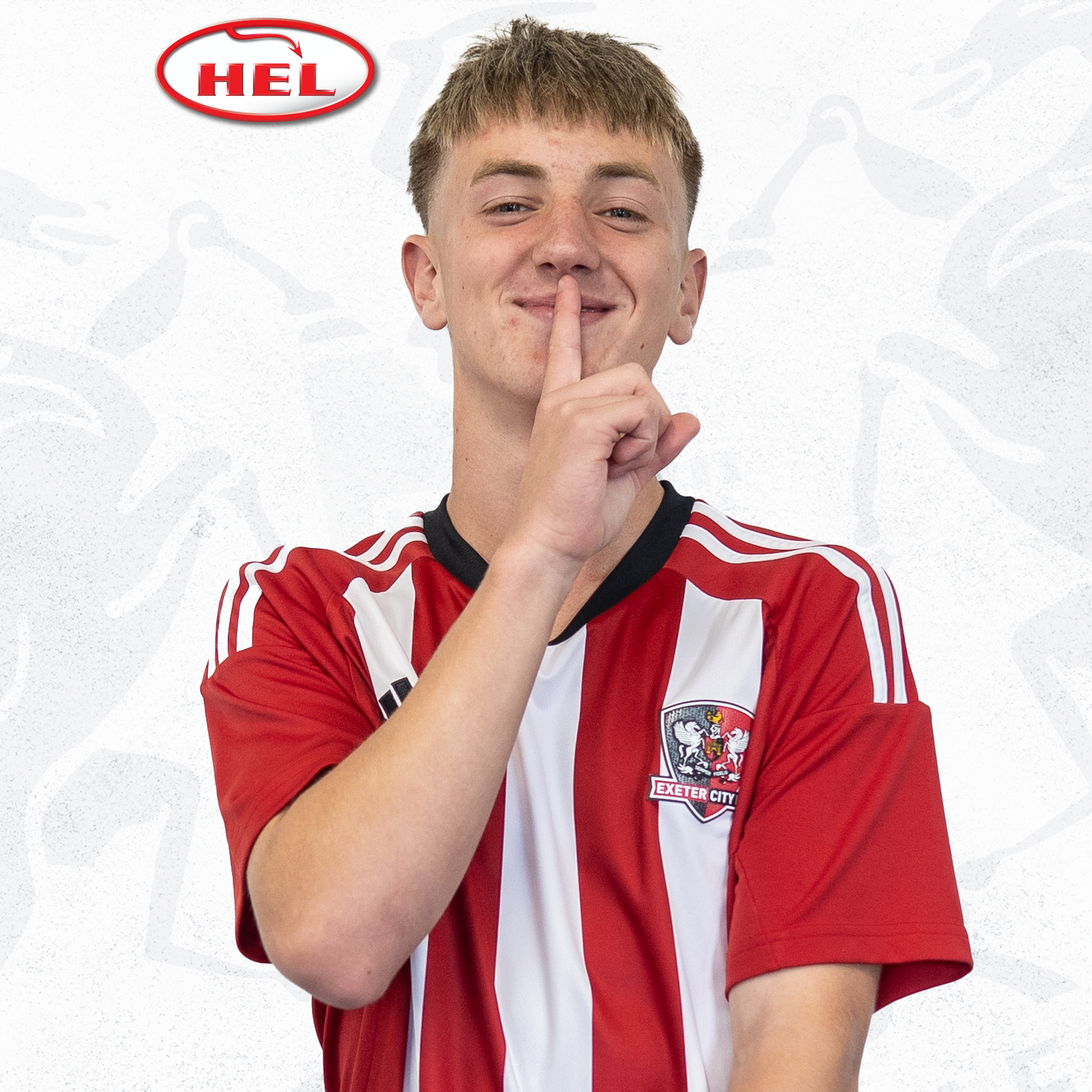 Under-18s player profile picture of Callum Graham. He's in the red and white home shirt, and has a blonde fringe. He's got his hand up to his lips in a 'shh' position. The HEL logo is in the corner.