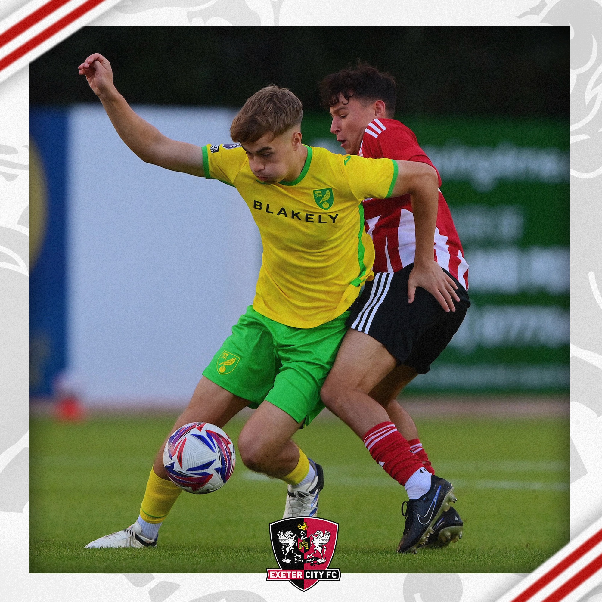 Louie Cayless battling for the ball with a Norwich midfielder