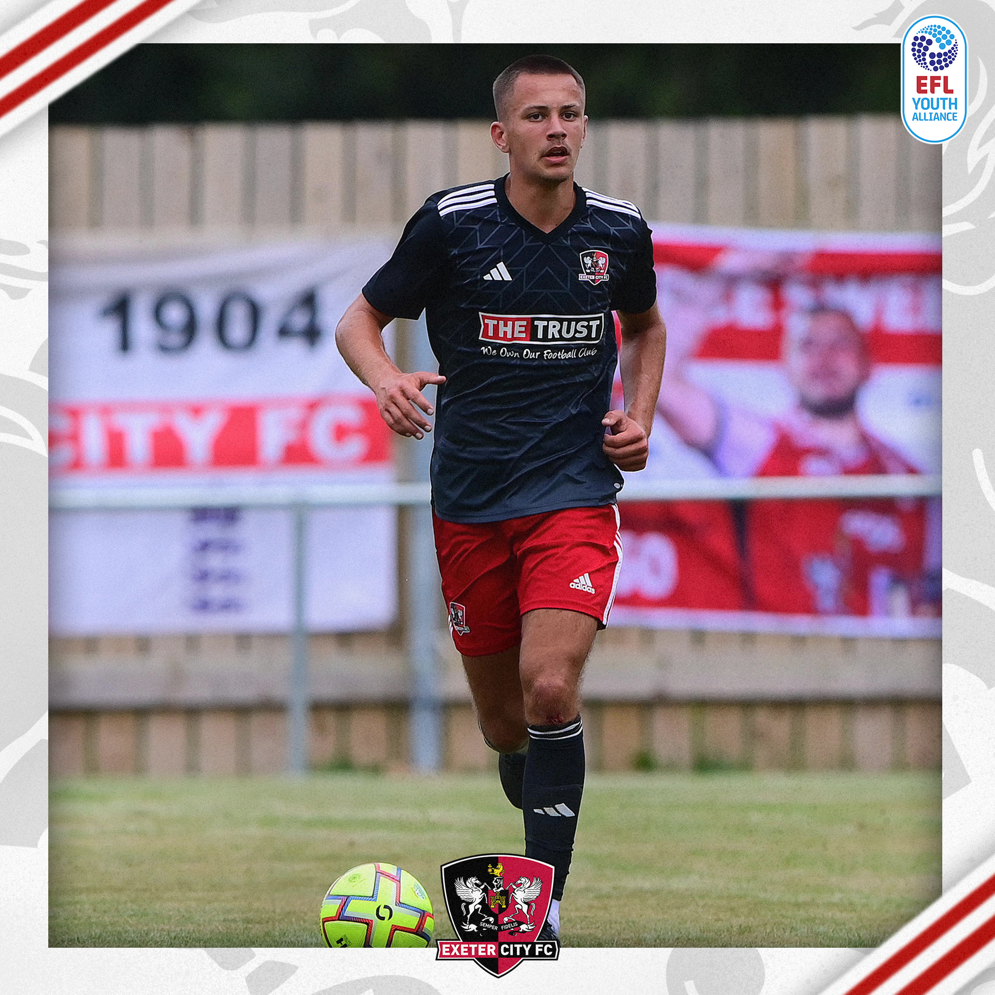 Image of Jack Anthony playing in City's black third kit from last season, with red shorts and black socks. He's dribbling out with the ball out his feet.