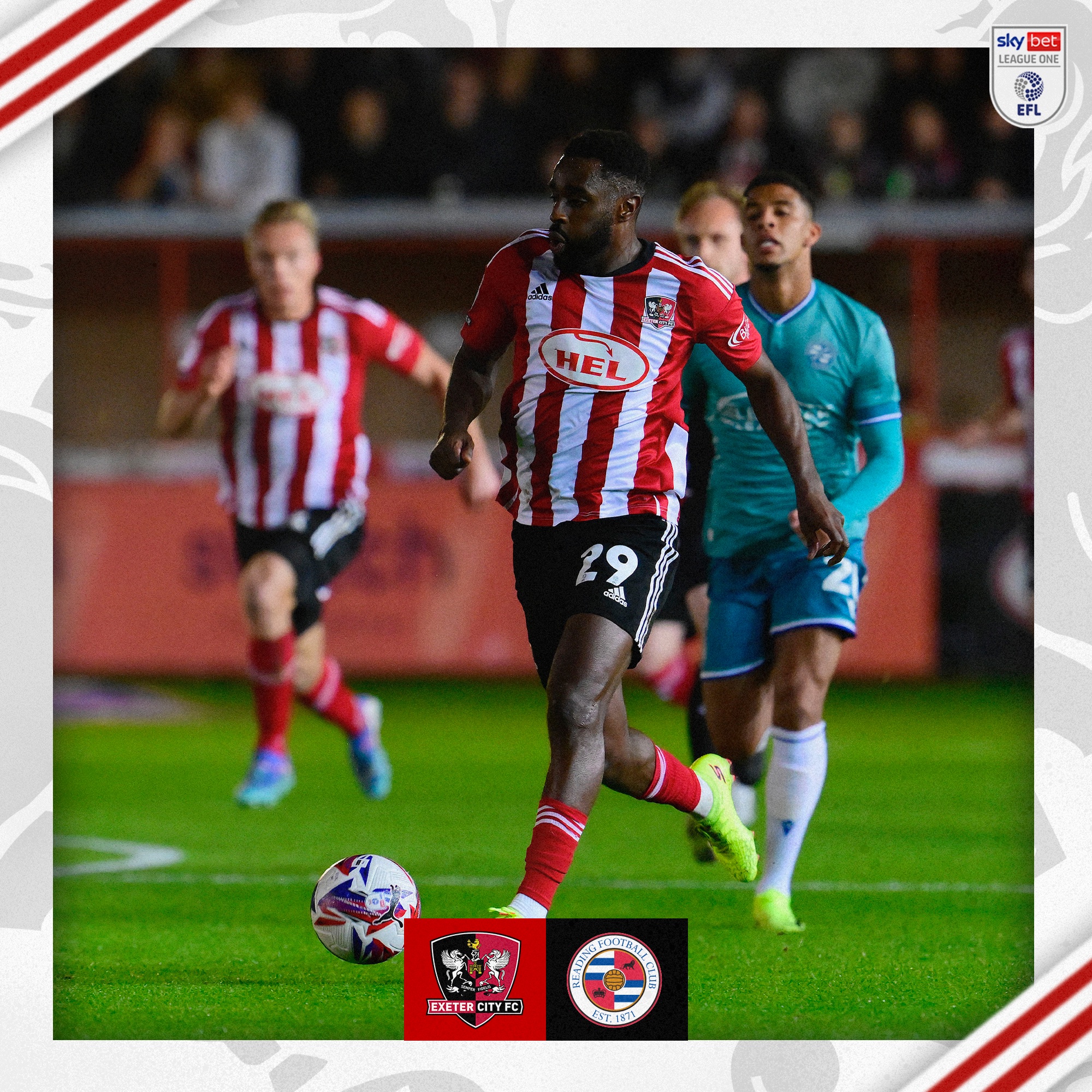 Mustapha Carayol running at the Reading defence, wearing his red and white home kit with the ball under his control, at his feet.