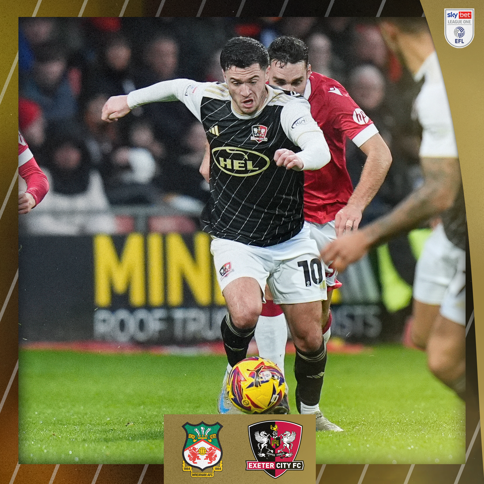 Jack Aitchison, in his black and white third kit, driving forward with the ball at his feet.