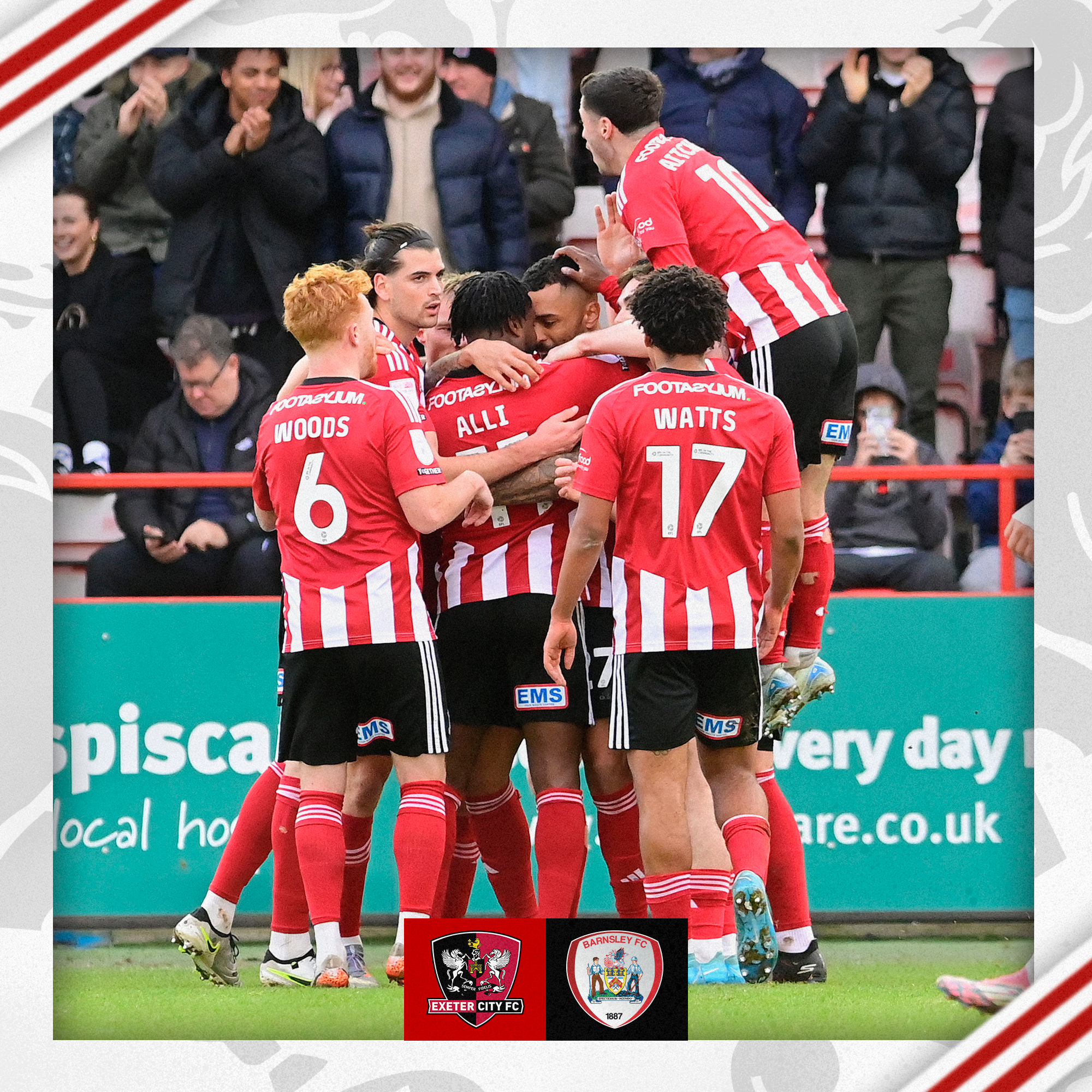 The players in red and white home shirts celebrating Josh Magennis' opener in a group together.