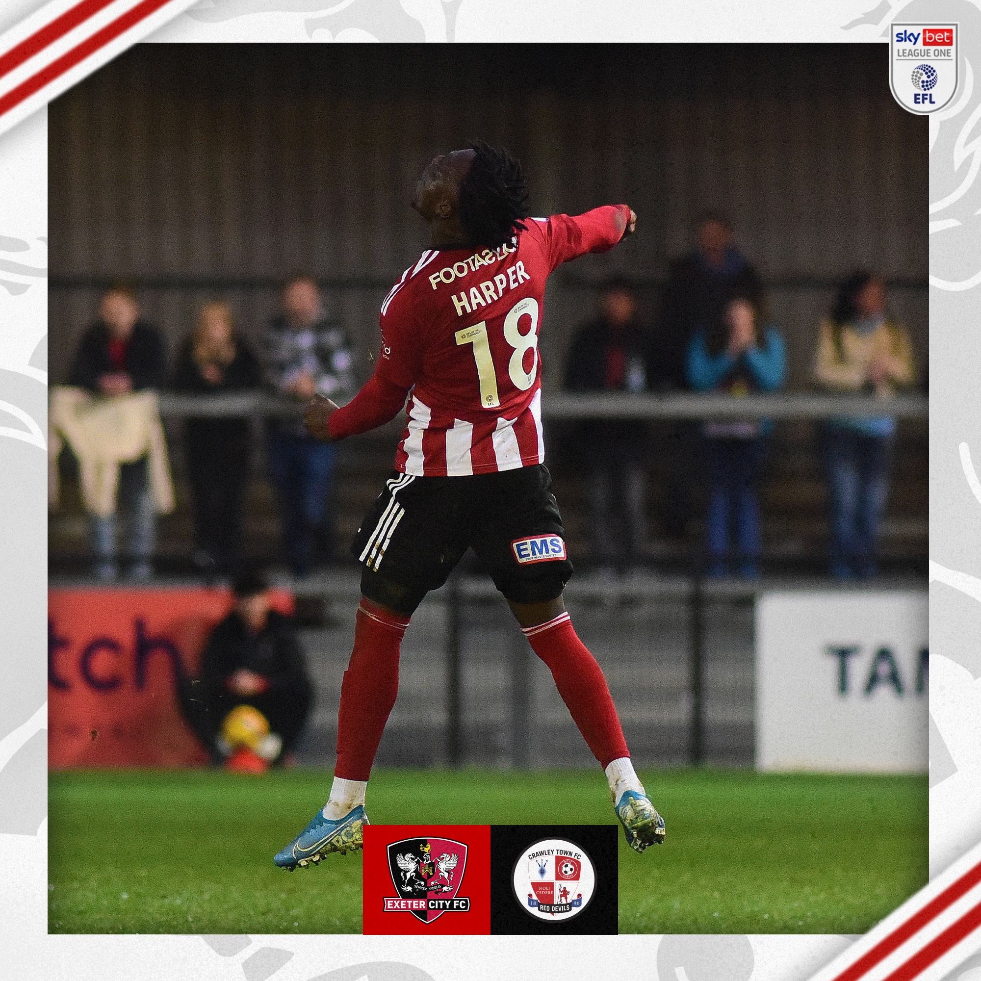 Vincent Harper, in his red and white home kit, celebrating his goal with a punch into the air, with his back to the photographer. 