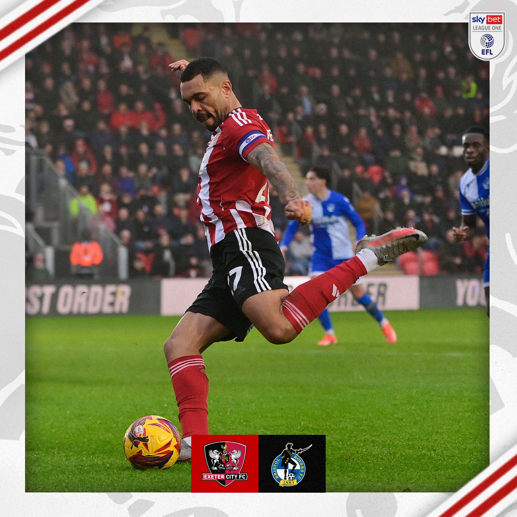 Josh Magennis, in his red and white home strip wearing the captain's armband, shooting toward goal