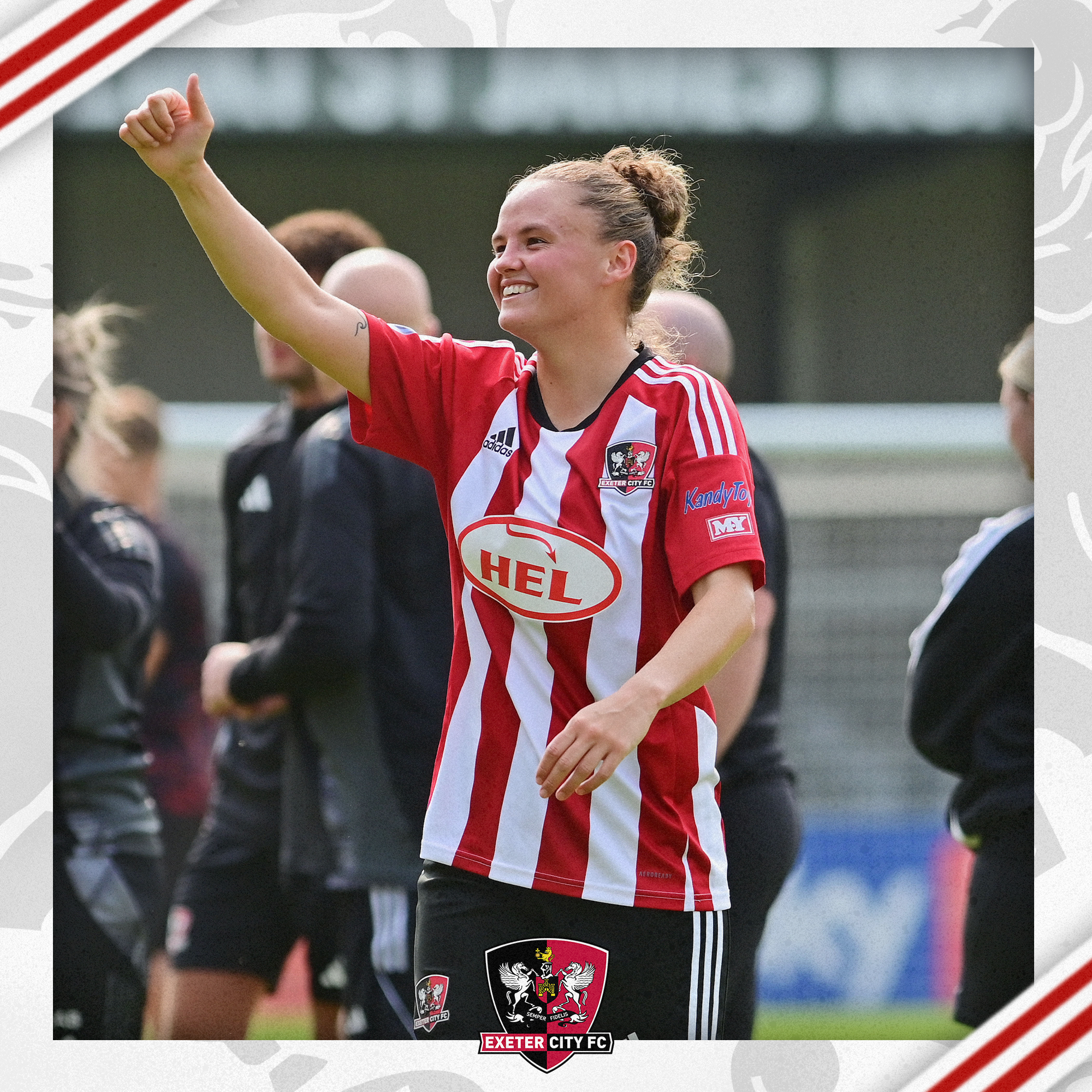 Jaydee Seaman, in her red and white Exeter City home strip, giving a thumbs up to the crowd.