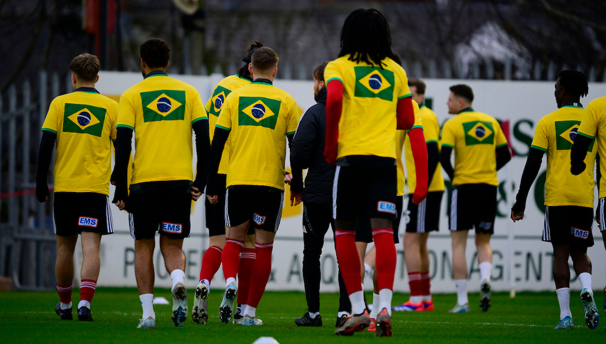 Exeter City players warming up in Brazil shirts