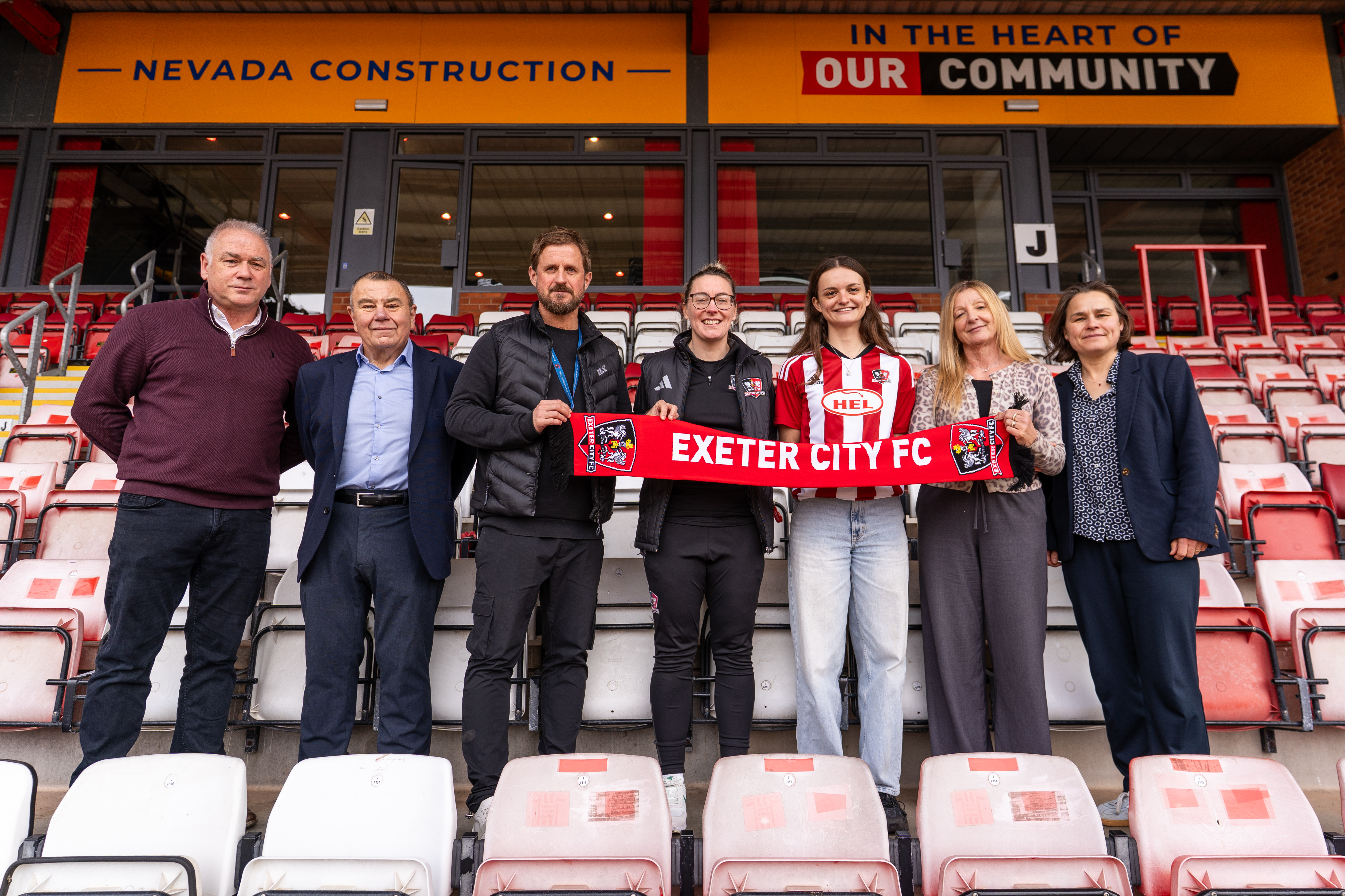 Sophie Gillies with members of the women's board after signing City Women's first ever contract