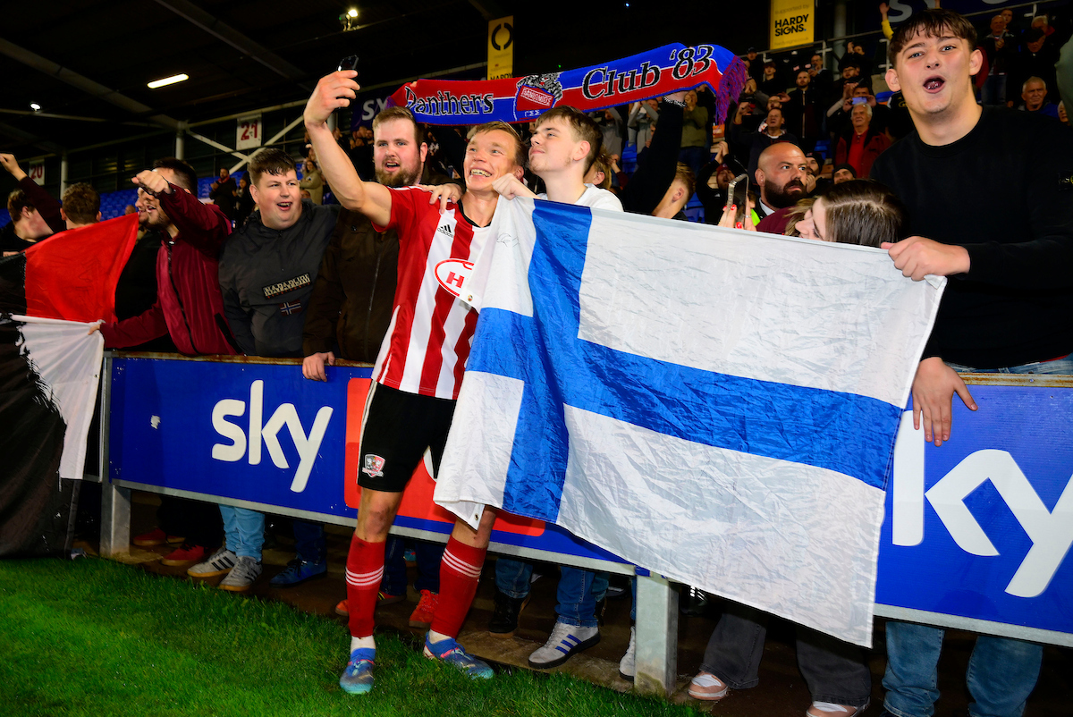 Ilmari niskanen with a finland flag and fans