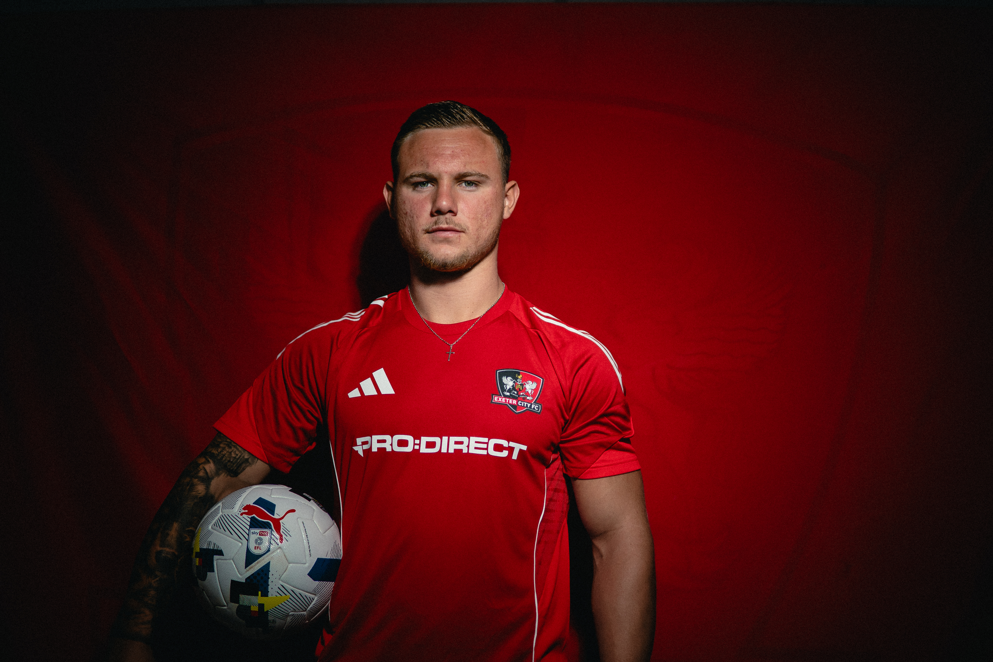 Image of Jayden Wareham looking down the camera, holding a ball