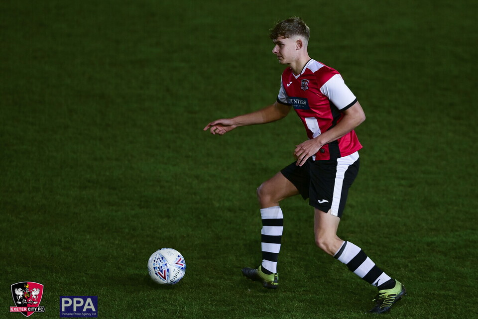 Alfie Pond on the ball, in Exeter City kit