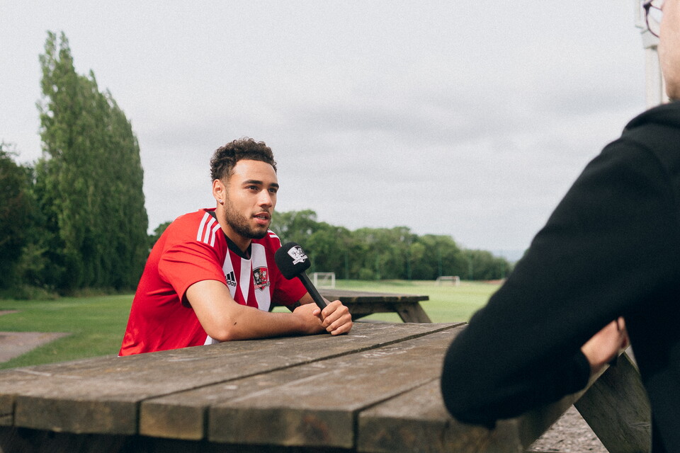 Jay Bird being interviewed, holding an ECFC branded microphone