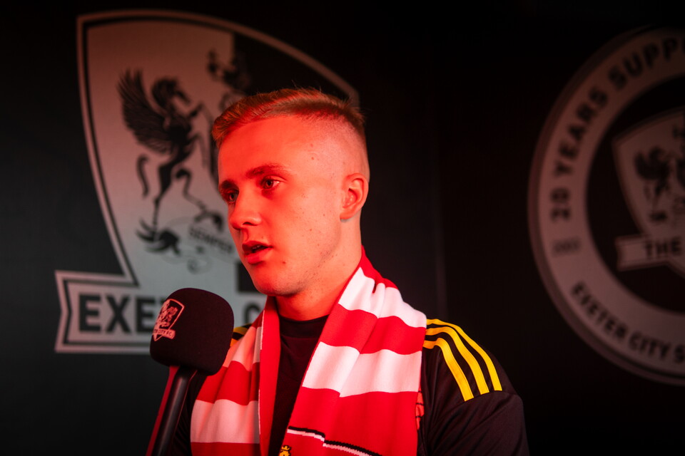 Joe Whitworth holding a microphone being interviewed