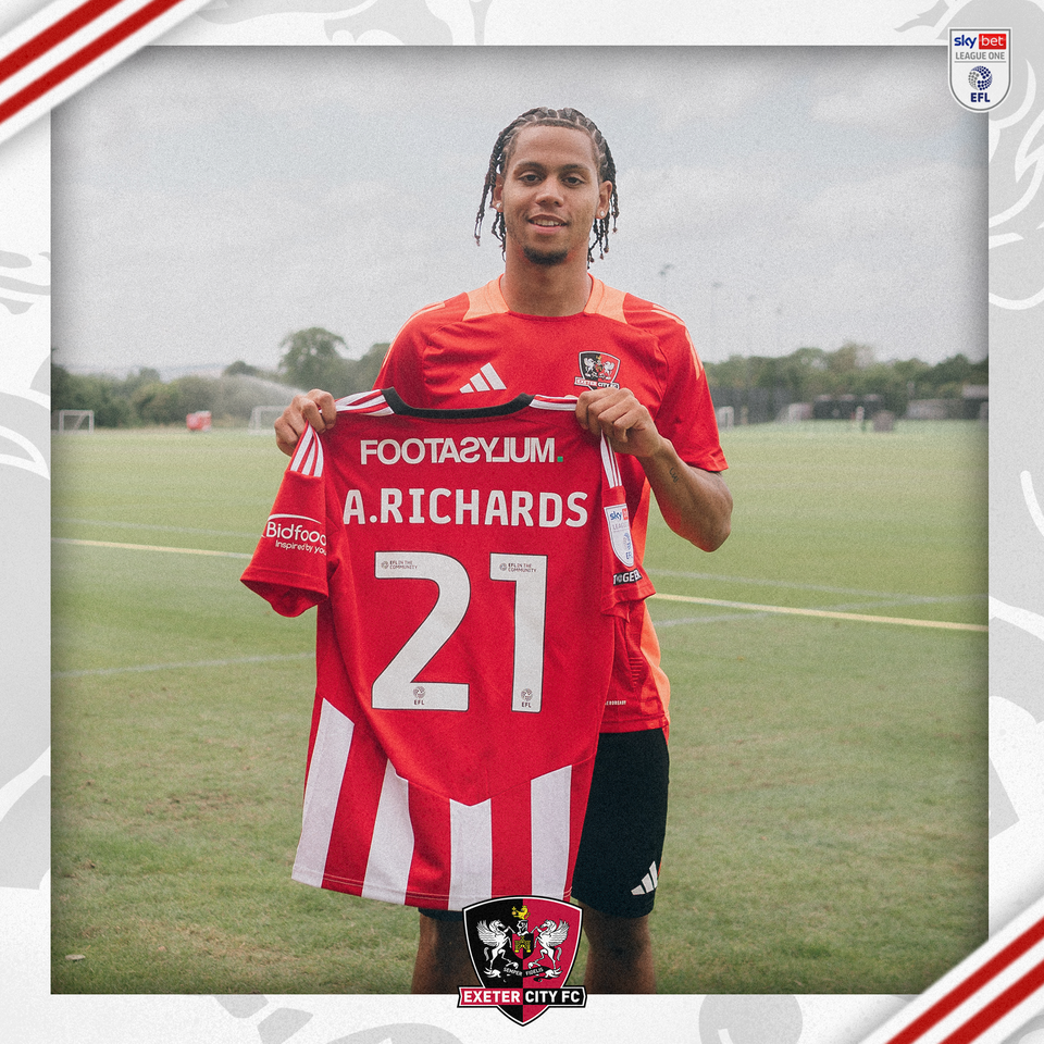 Amani Richards holding his number 21 shirt