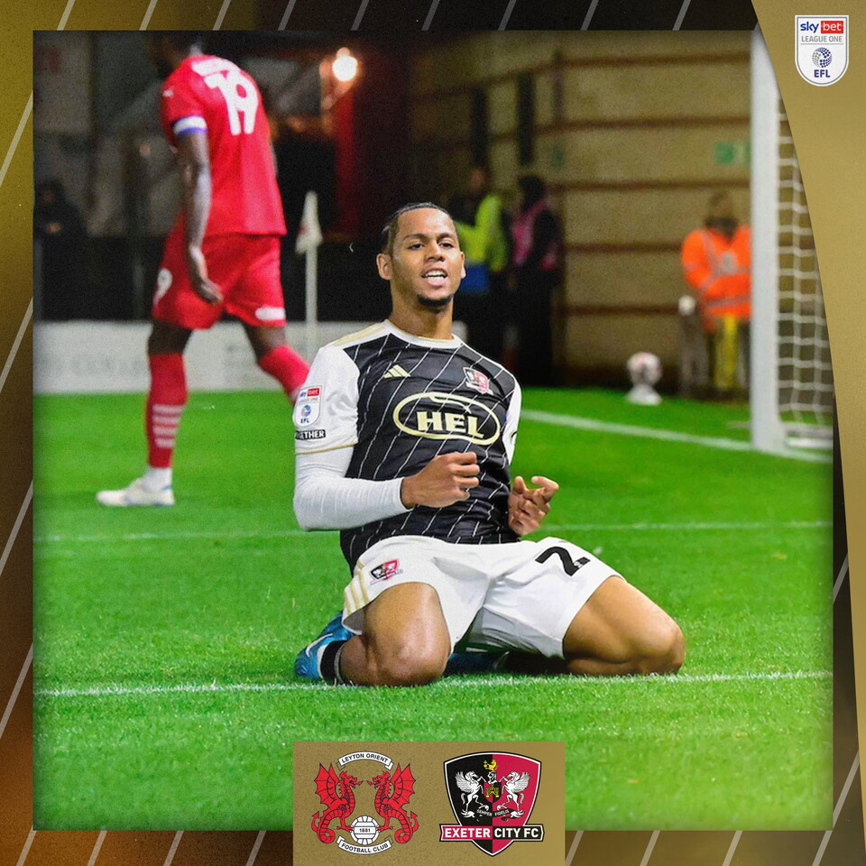 Amani Richards celebrating his goal with a knee slide towards the camera.