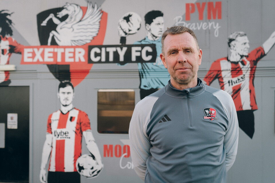 David Oldfield standing in front of the academy building at Exeter City