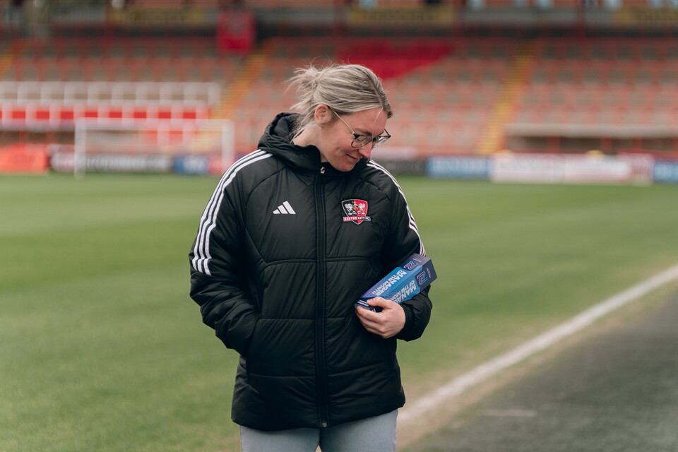 Image of Abbie Britton looking at her manager of the month award
