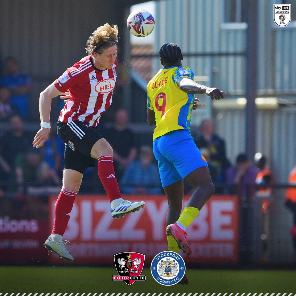 Alex Hartridge battling for an aerial ball against a Stockport player