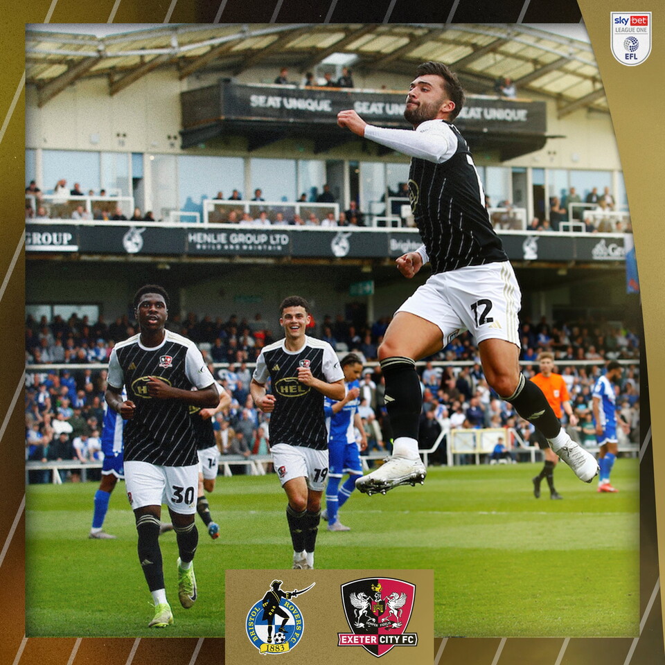 Reece Cole celebrating his goal with a jumping fist towards the crowd, with Tony Yogane and Sonny Cox running toward him