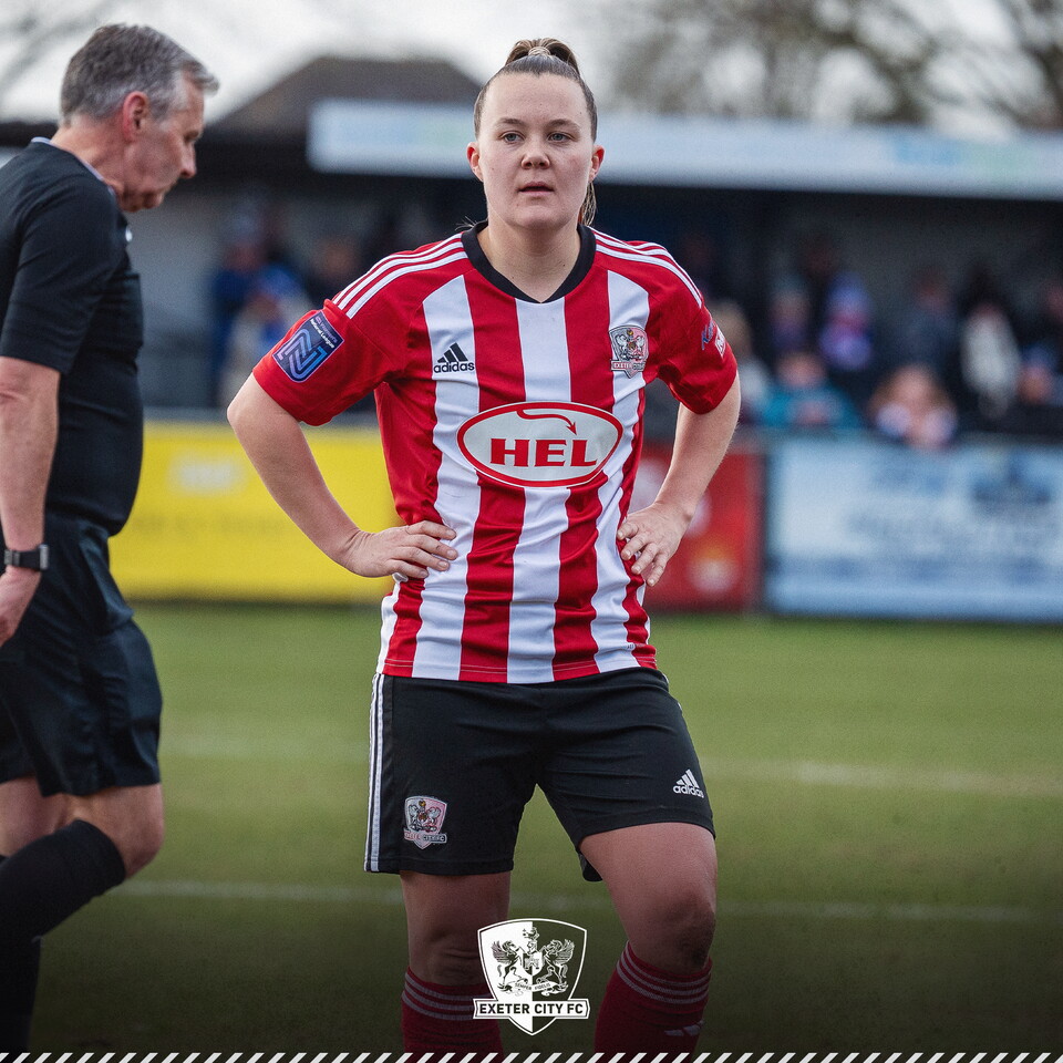 Phoebe Baker standing during the middle of a game