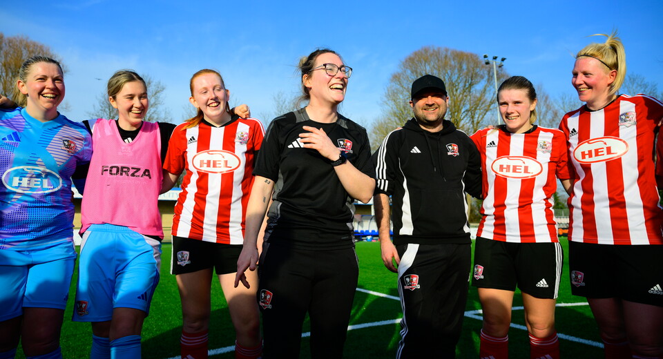 Abbie Britton in the middle of a team huddle