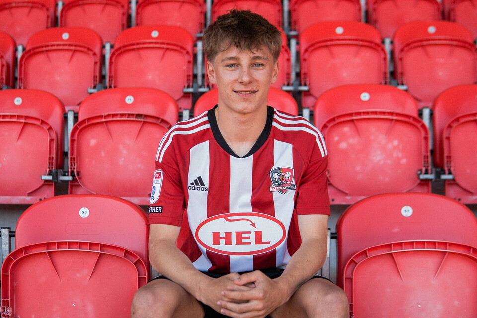 George Birch, sat in his Exeter City kit in the stands at St James Park