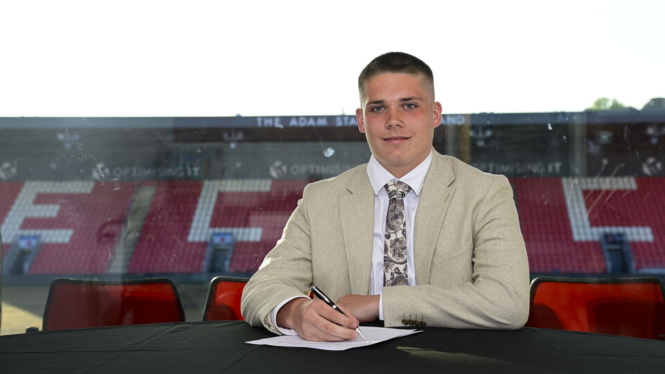 Sam Down signing his scholarship