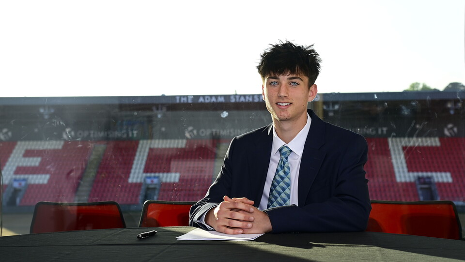 Image of Jamie Rickhuss signing his scholarship