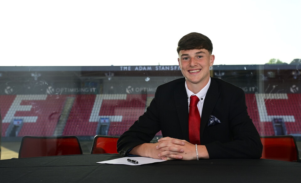 Henry Revell signing his scholarship