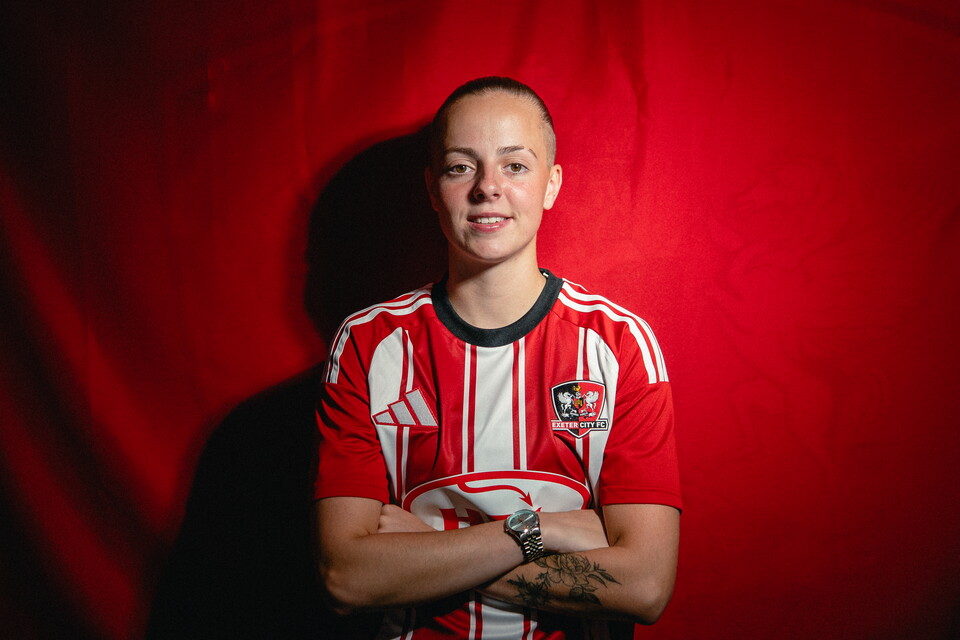 Image of Ellie Sara with her arms crossed facing the camera