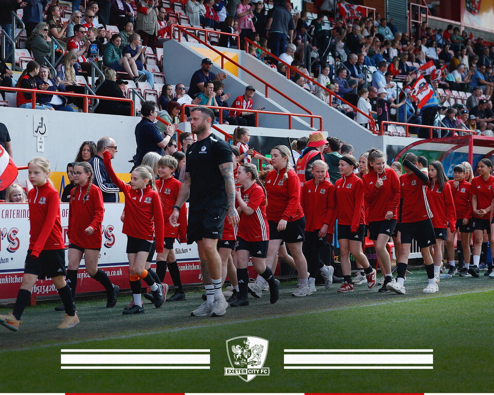 Girls' Pathway players walking on the pitch at St James Park