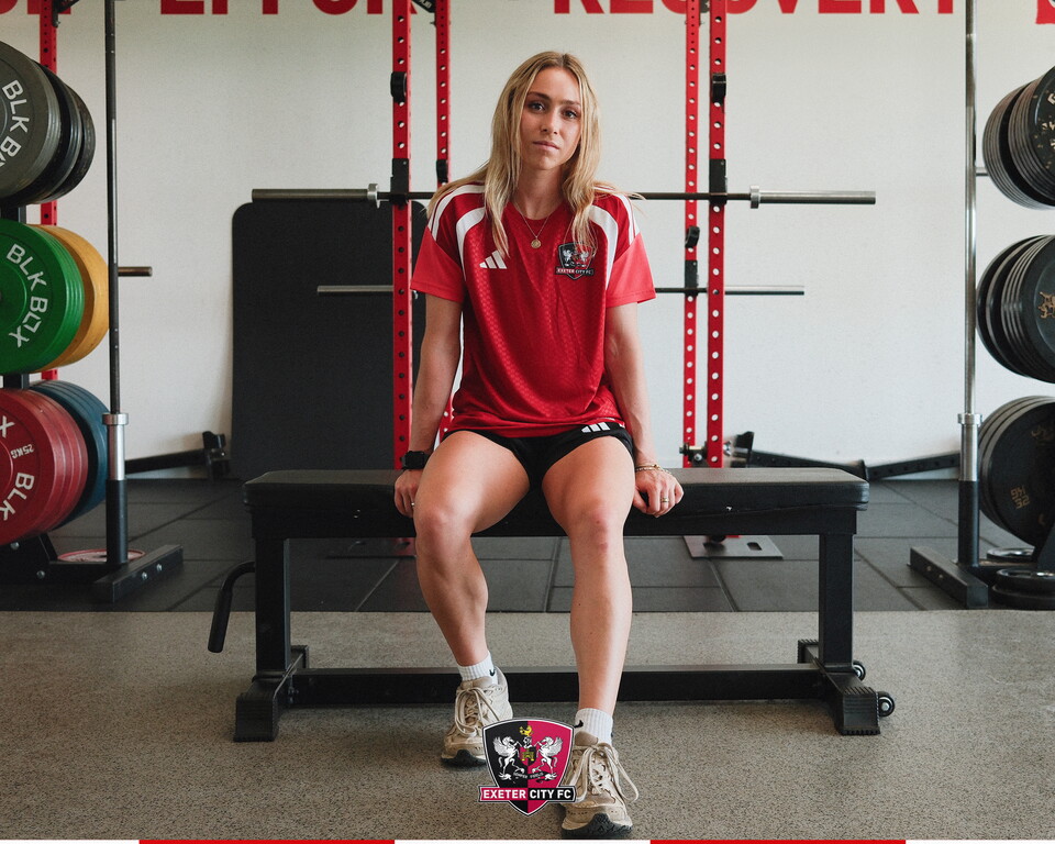 Image of Maya Kendell sat in the gym at the Cliff Hill Training Ground, on a workout bench