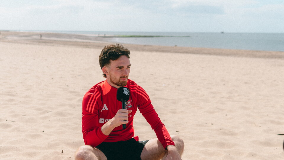 Ed Francis sat on the beach, speaking into a microphone