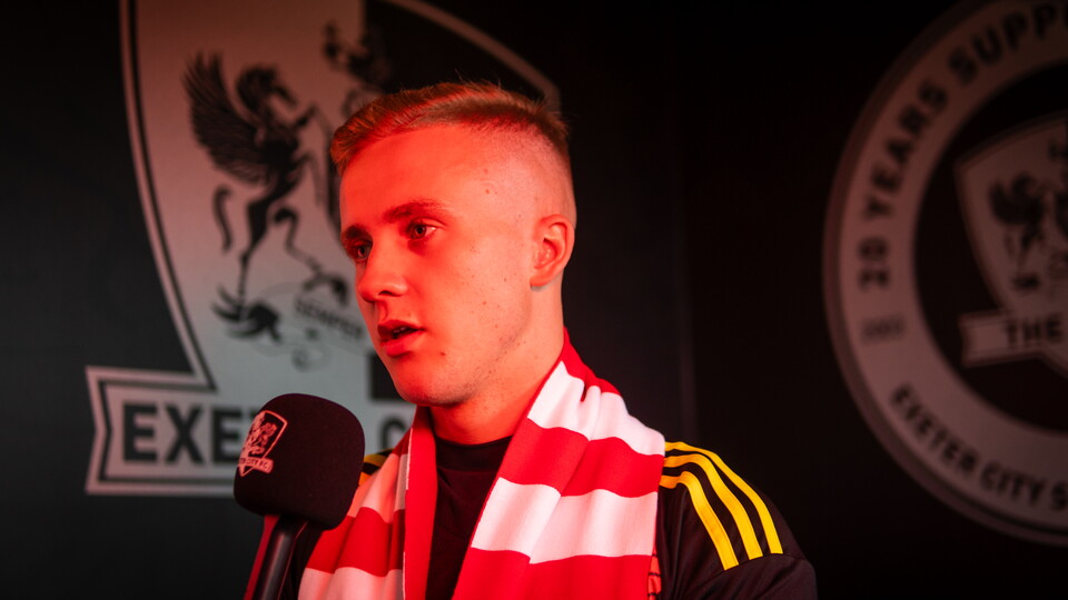 Joe Whitworth holding a microphone being interviewed