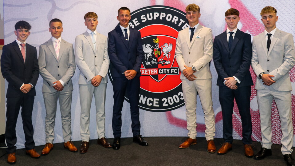 Images of the scholars, dressed in suits, in front of the ECFCST Board