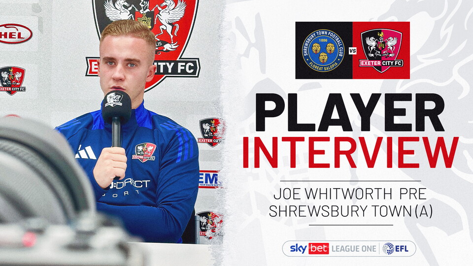 Joe Whitworth holding a microphone being interviewed