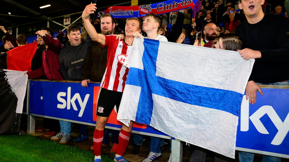 Ilmari niskanen with a finland flag and fans