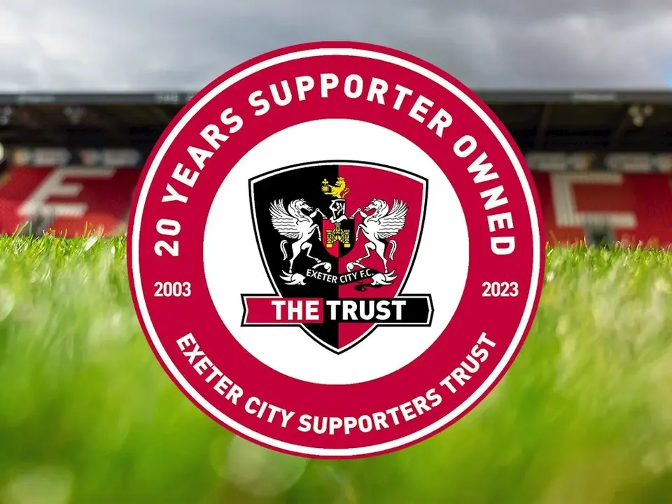 The ECFC Supporters' Trust logo on top of an image of the pitch and the Adam Stansfield Stand